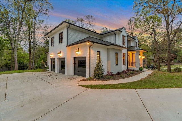 view of front facade featuring a garage, brick siding, and driveway