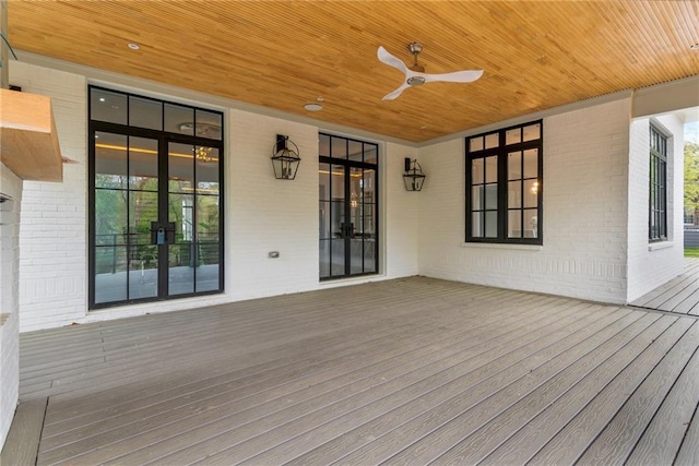 wooden terrace with french doors and a ceiling fan