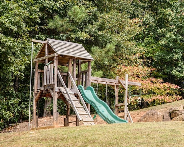 view of jungle gym featuring a lawn