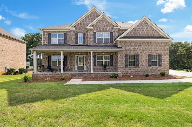 craftsman-style home featuring a porch and a front lawn