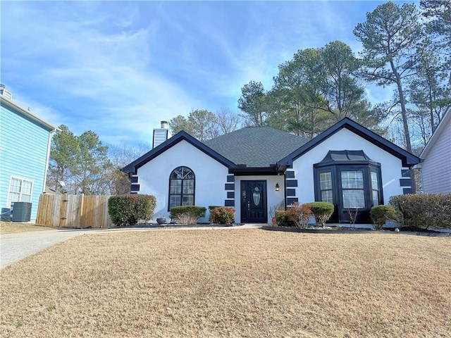 ranch-style home with central AC and a front lawn