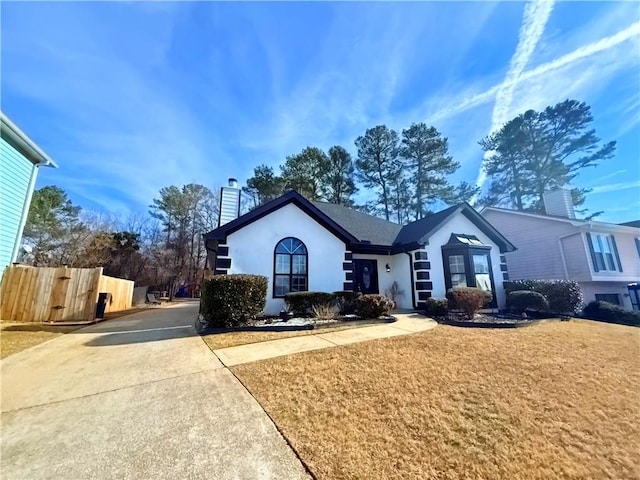 ranch-style home with a front lawn