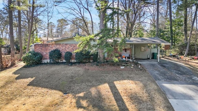 single story home with a carport, board and batten siding, and driveway