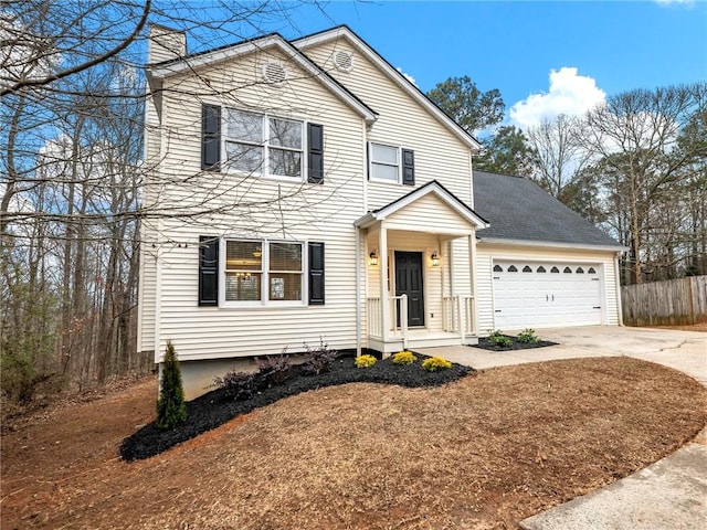 traditional-style home with a garage, concrete driveway, a chimney, roof with shingles, and fence