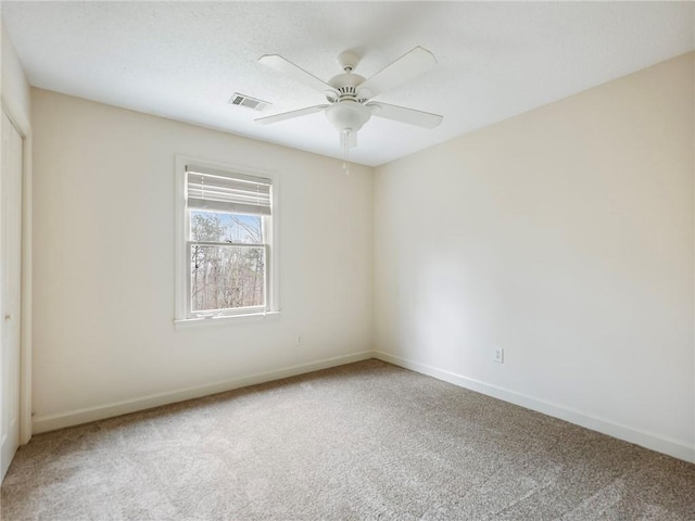 unfurnished room with ceiling fan and carpet flooring