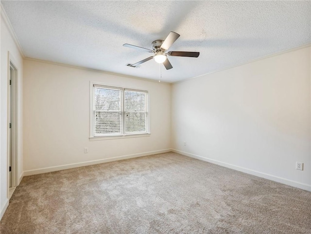 unfurnished room with ornamental molding, carpet, a textured ceiling, and ceiling fan