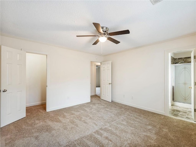 unfurnished bedroom with crown molding, light colored carpet, ensuite bathroom, and a textured ceiling