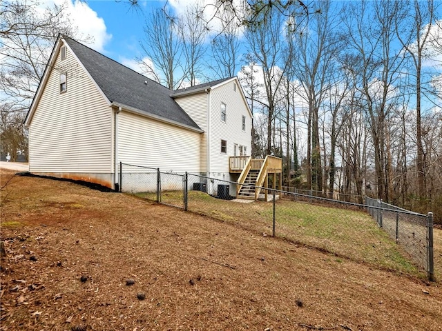 view of property exterior with a lawn and a deck