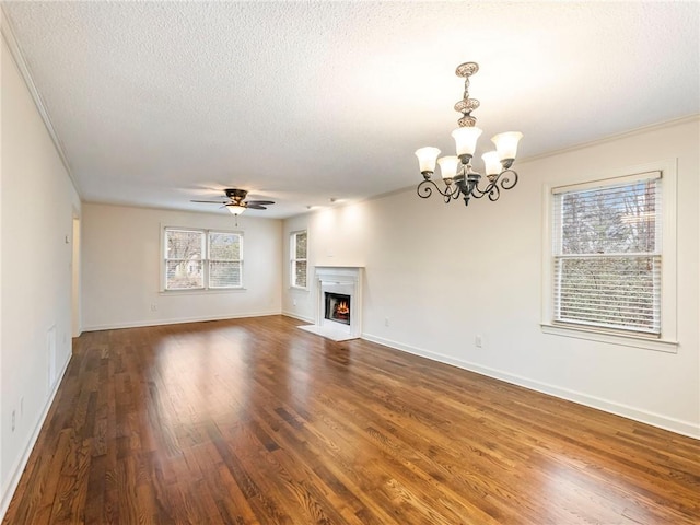 unfurnished living room with dark hardwood / wood-style flooring, ceiling fan with notable chandelier, and a textured ceiling