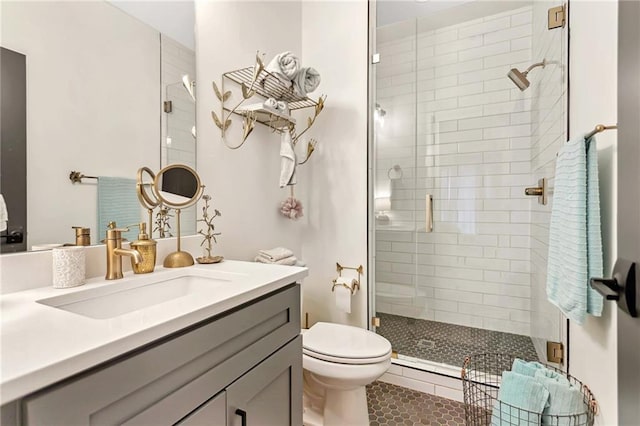 bathroom featuring toilet, vanity, an enclosed shower, and tile patterned floors