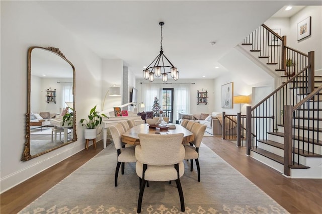 dining room featuring an inviting chandelier and dark hardwood / wood-style flooring