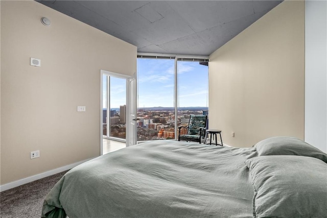 bedroom with carpet floors, expansive windows, and baseboards