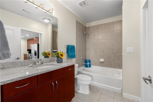 bathroom featuring toilet, vanity, visible vents, and tile patterned floors