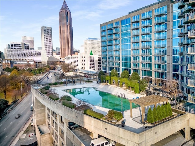 view of swimming pool featuring a city view