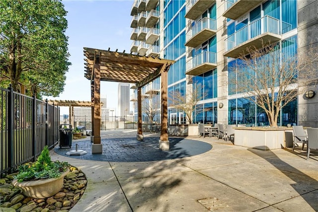 view of home's community featuring fence and a pergola