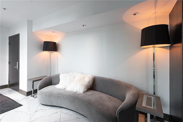 living room with marble finish floor and baseboards