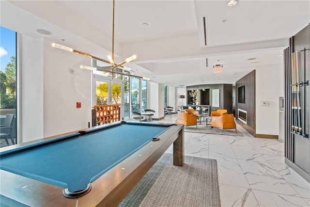 recreation room with marble finish floor, billiards, baseboards, and an inviting chandelier