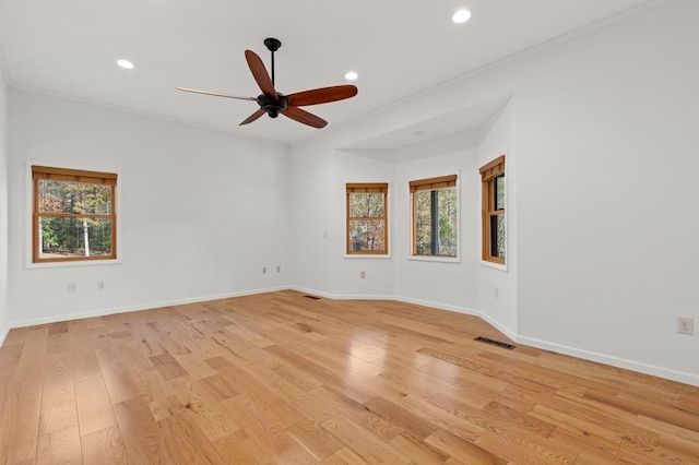 unfurnished room featuring ceiling fan, light wood-type flooring, and ornamental molding