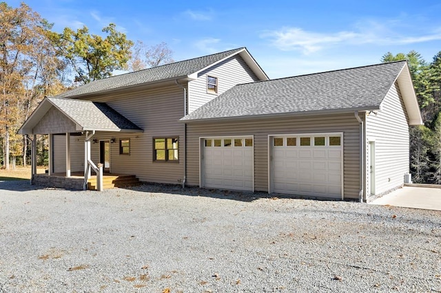 view of front of house with a porch and a garage