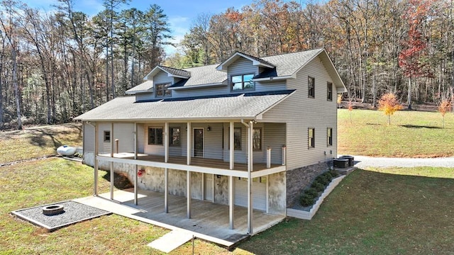 view of front facade with central air condition unit, a front lawn, and a garage