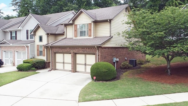 view of front of home featuring brick siding, driveway, roof with shingles, central AC, and a garage
