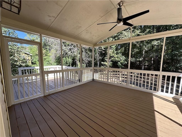 unfurnished sunroom featuring lofted ceiling and ceiling fan