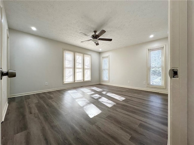 spare room with baseboards, a ceiling fan, dark wood-type flooring, a textured ceiling, and recessed lighting