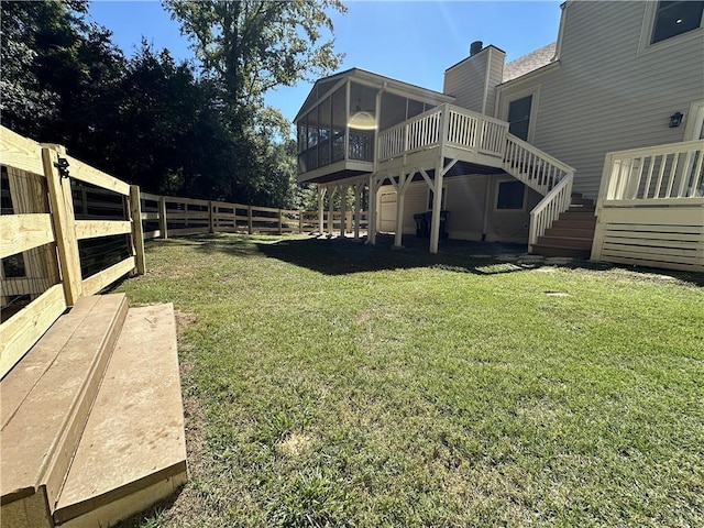 view of yard with a sunroom, stairs, fence, and a deck