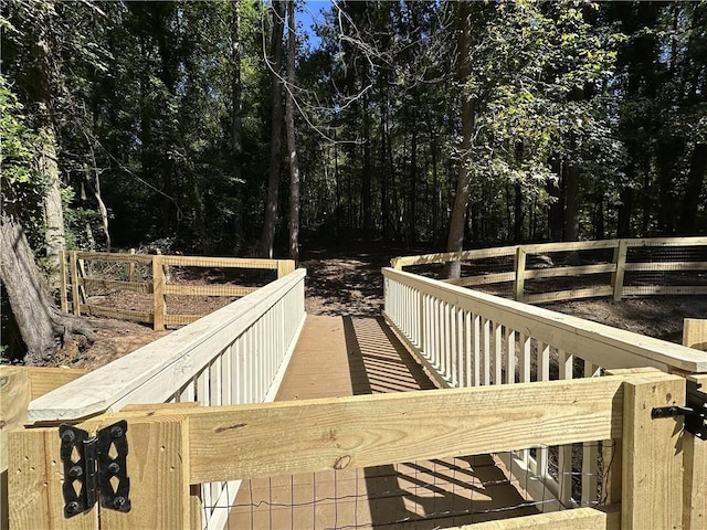 wooden terrace featuring fence