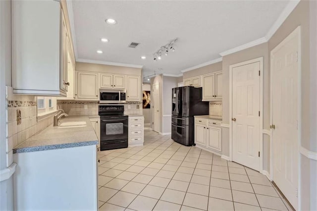 kitchen featuring decorative backsplash, sink, light tile patterned floors, and black appliances