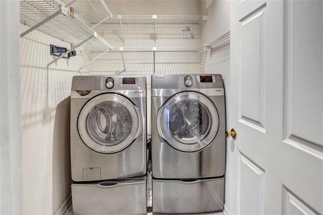 clothes washing area with separate washer and dryer