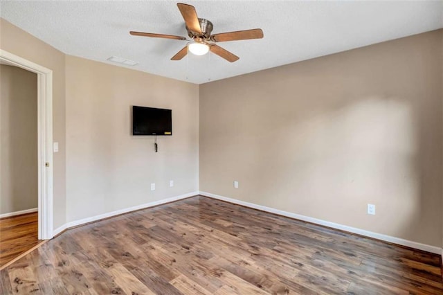 empty room featuring ceiling fan and hardwood / wood-style flooring