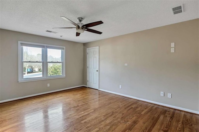 empty room featuring hardwood / wood-style floors and a textured ceiling