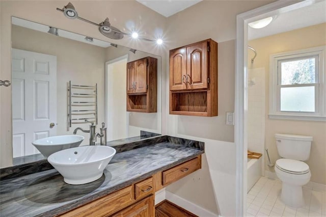 full bathroom with toilet, shower / washtub combination, tile patterned flooring, radiator, and vanity