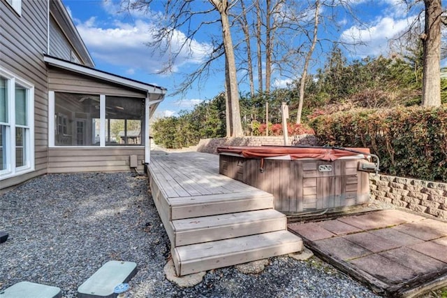 wooden terrace featuring a sunroom and a hot tub