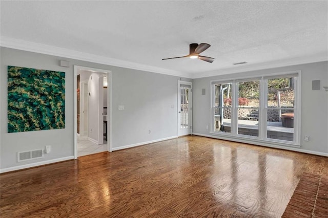 empty room with ceiling fan, ornamental molding, and hardwood / wood-style flooring