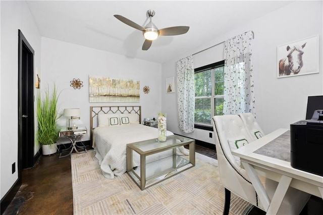 bedroom with finished concrete floors, rail lighting, and a ceiling fan