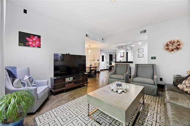 living room featuring concrete floors and recessed lighting
