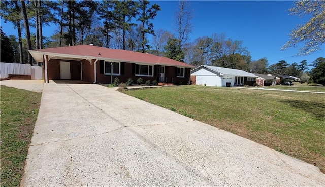 single story home featuring a carport, concrete driveway, a front lawn, and fence