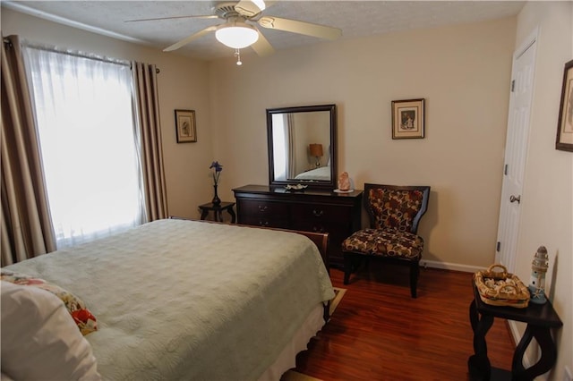 bedroom featuring dark wood-type flooring and ceiling fan