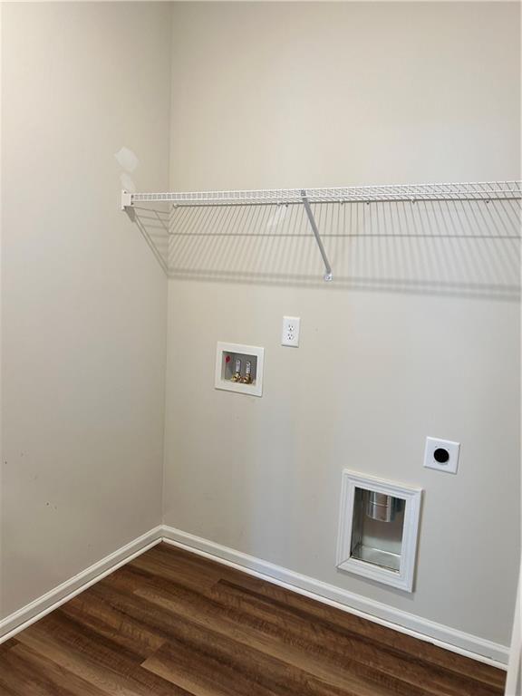 clothes washing area with hardwood / wood-style flooring, electric dryer hookup, and washer hookup