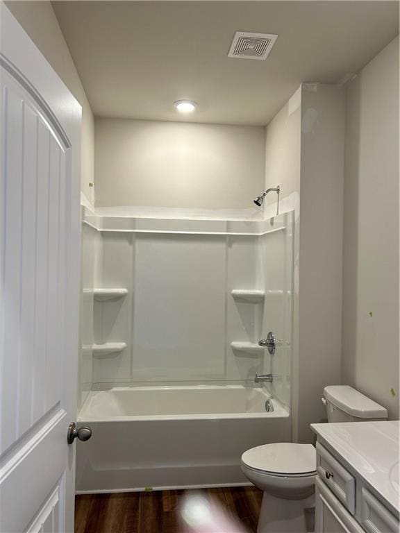 full bathroom featuring hardwood / wood-style floors, vanity, toilet, and shower / bathtub combination