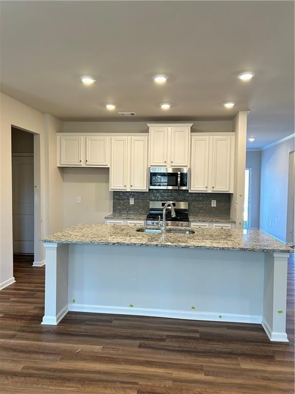 kitchen with dark hardwood / wood-style flooring, backsplash, white cabinetry, and sink