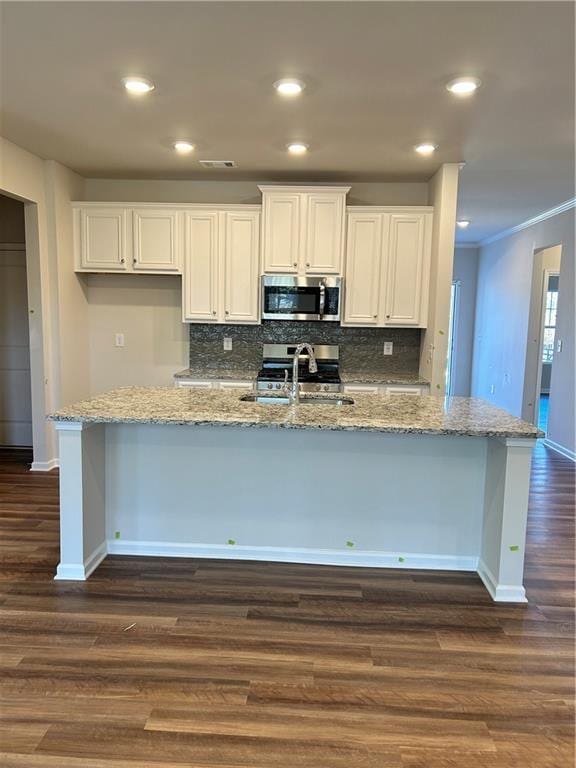 kitchen featuring white cabinetry, sink, dark wood-type flooring, decorative backsplash, and ornamental molding