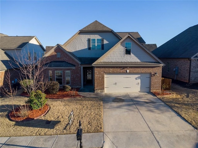 craftsman-style home featuring a garage, driveway, and brick siding