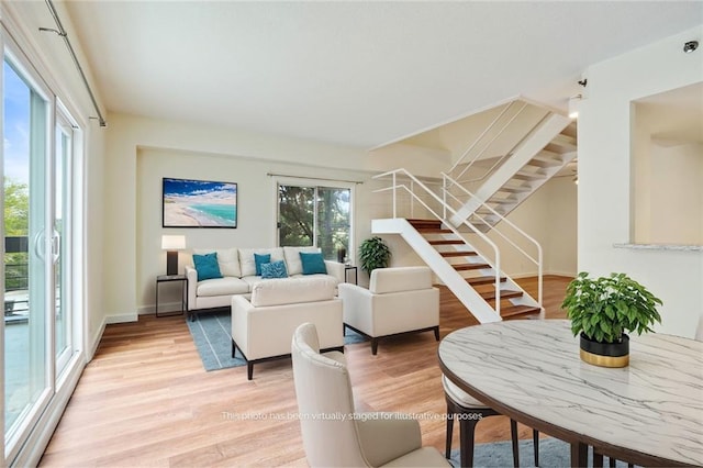 587 Virginia Ave NE Unit 315, Atlanta, GA 30306 - living area with stairway, plenty of natural light, light wood-style floors, and baseboards