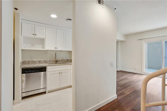 587 Virginia Ave NE Unit 315, Atlanta, GA 30306 - kitchen featuring a sink, white cabinetry, visible vents, and stainless steel dishwasher