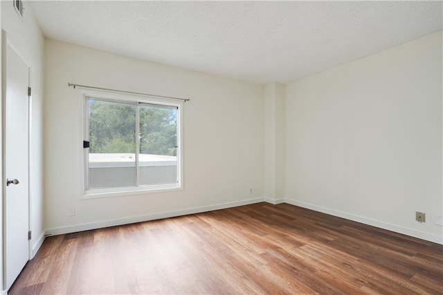 587 Virginia Ave NE Unit 315, Atlanta, GA 30306 - spare room with visible vents, baseboards, and wood finished floors
