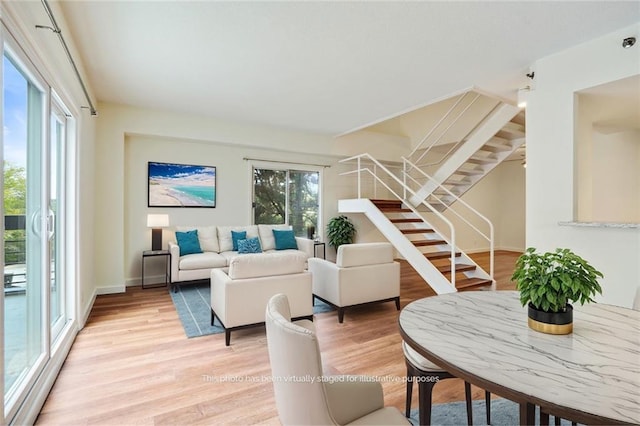 587 Virginia Ave NE Unit 315, Atlanta, GA 30306 - living room with baseboards, plenty of natural light, light wood-style flooring, and stairs