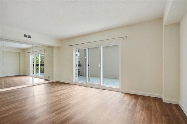 587 Virginia Ave NE Unit 315, Atlanta, GA 30306 - empty room featuring visible vents, wood finished floors, and baseboards